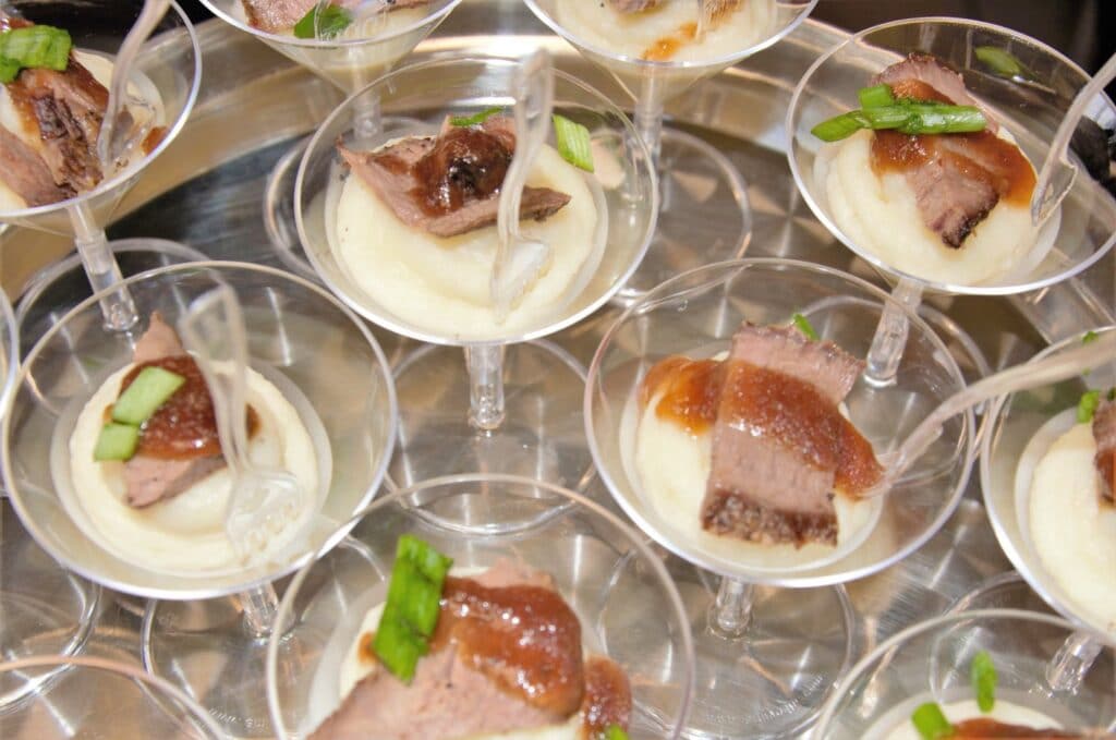 appetizers served in martini glasses ready to be handed out to guests at wedding reception