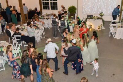 looking down from second floor onto guests dancing at wedding