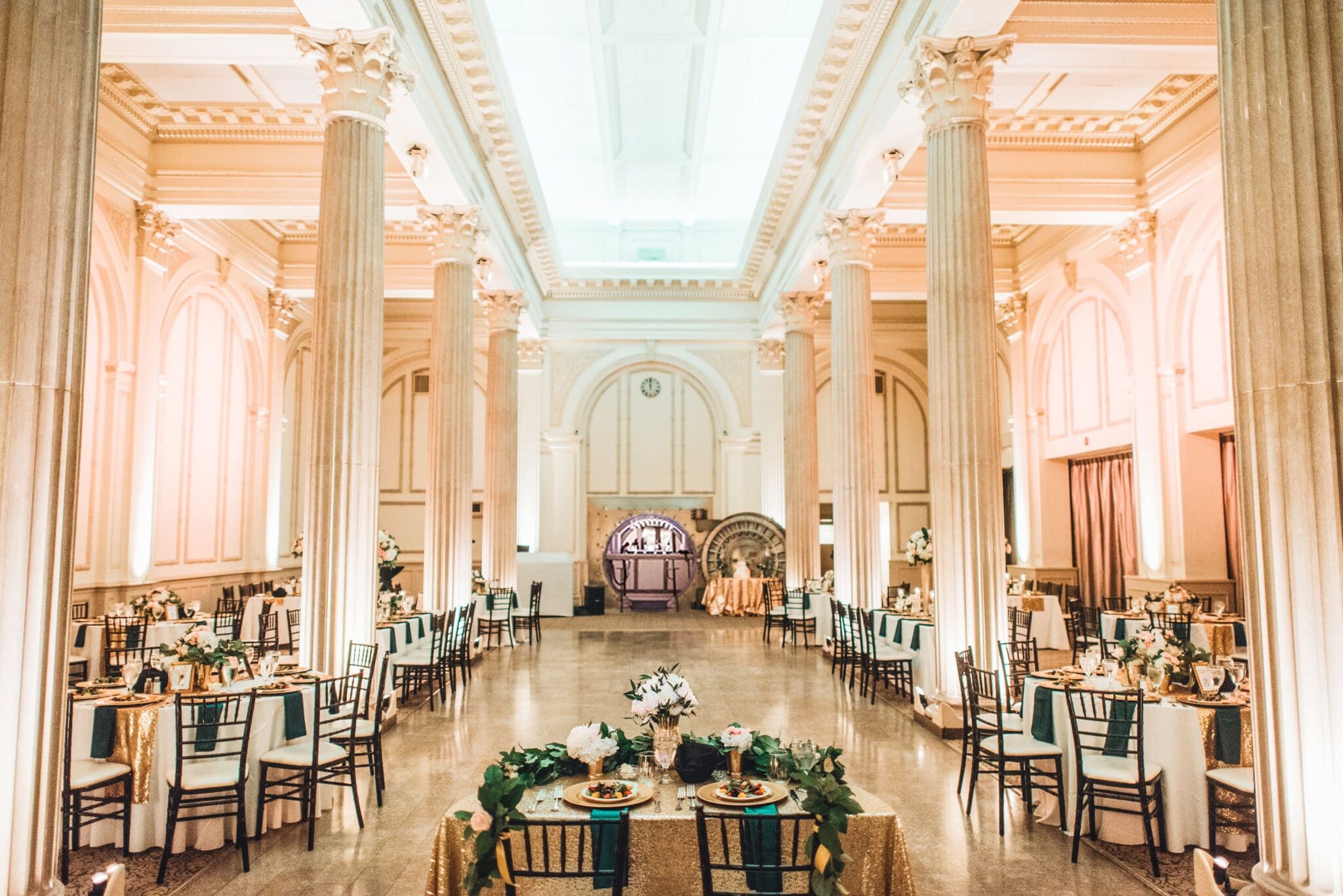 wedding reception area at the treasury on the plaza filled with white and gold accent pieces