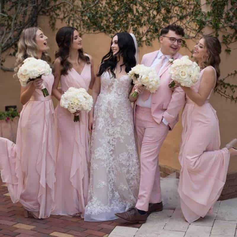 bride smiling with her bridesmaids while standing in an outdoor courtyard at Bella Collina