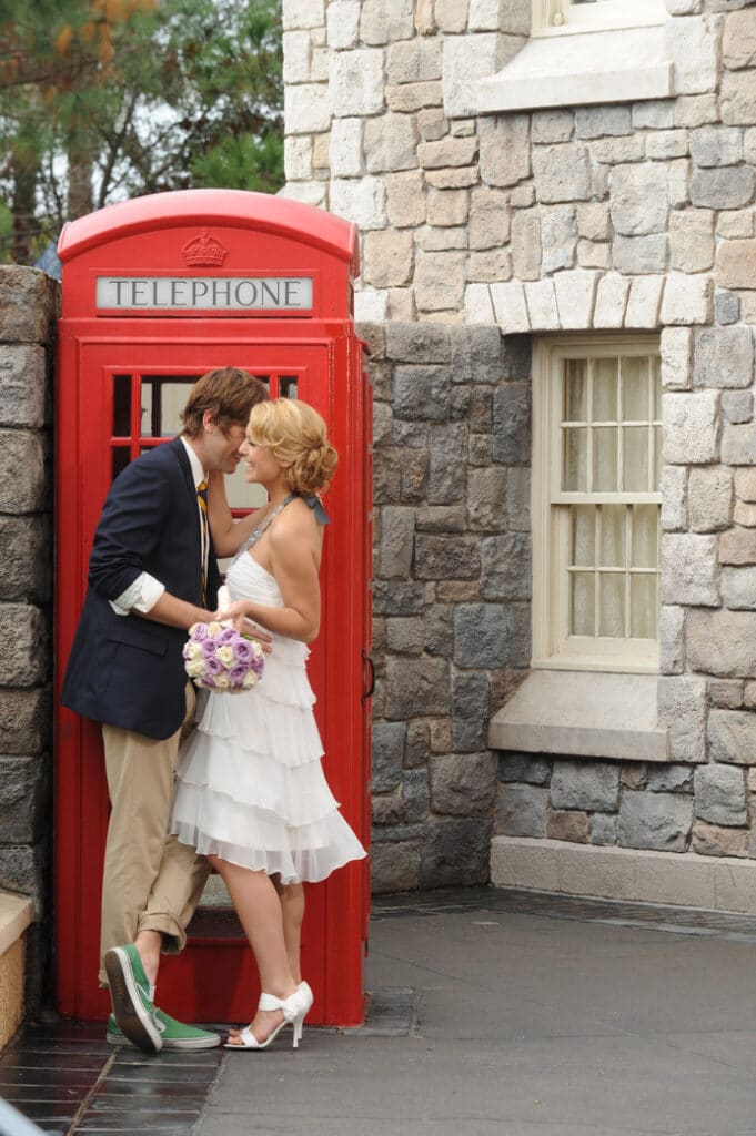 couple in front of old red telephone booth