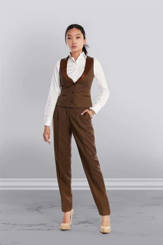woman wearing brown dress pants and a matching brown tux vest with a white dress shirt