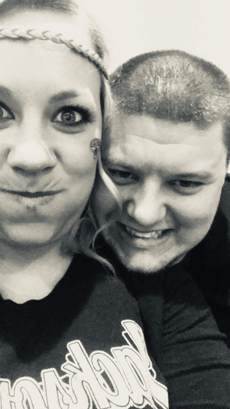 close up picture of young couple making silly faces while looking at the camera in black and white