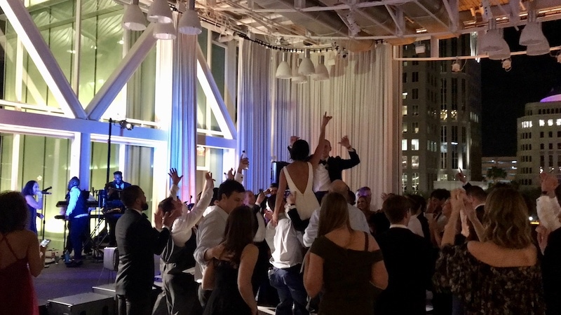 bride and groom dancing while Paradigm Party Band performs