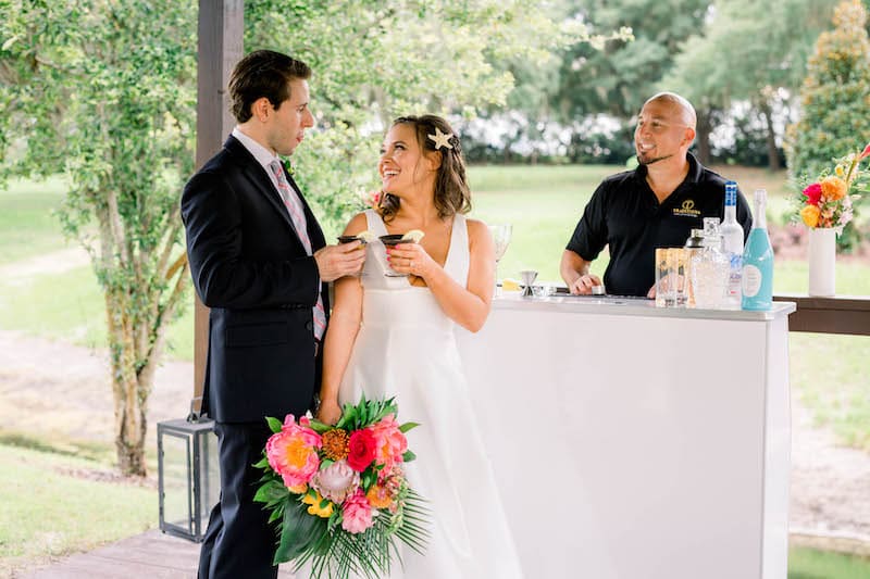 bride and groom enjoying a cocktail on their wedding day