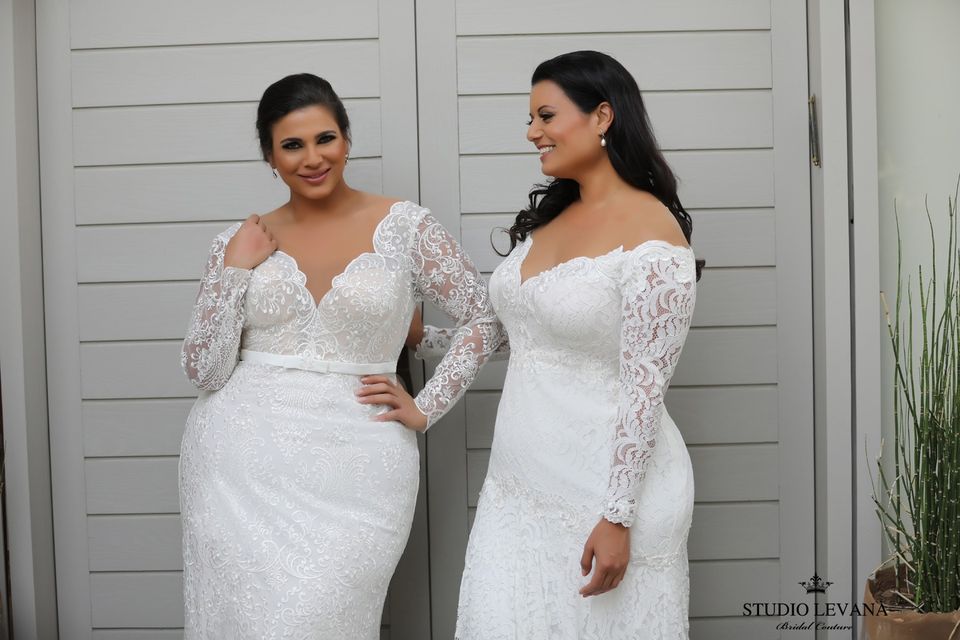 two brides posing in their wedding dresses