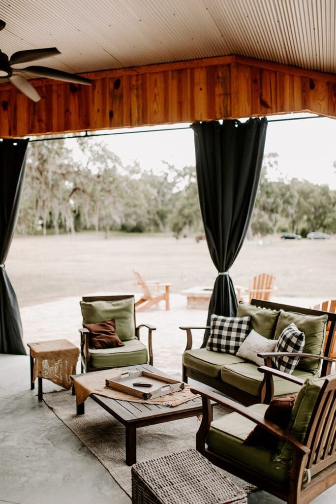 loveseat and chairs in open-air covered area for relaxing and eating at legacy at oak meadows