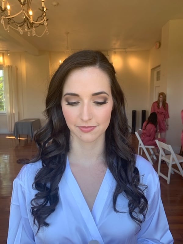 bride in white bath robe closing her eyes to show off makeup from Marissa Renee Artistry
