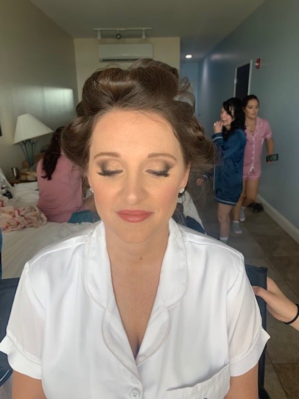 bride in robe closing her eyes showing off makeup prepared by Marissa Renee Artistry