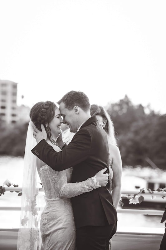 bride and groom kissing and laughing after getting married