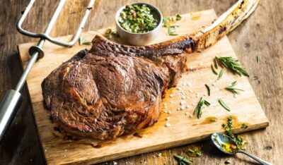 dry aged tomahawk steak featured at Fogo de Chao