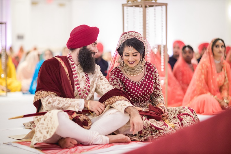 bride and groom sitting during wedding ceremony coordinated by Eventrics Weddings