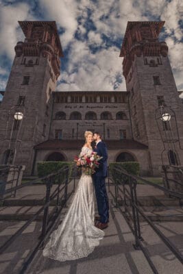 bride and groom standing outside of building in St. Augustine, FL