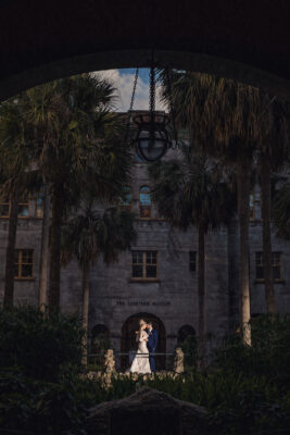 bride and groom standing outside of The Lightner Museum