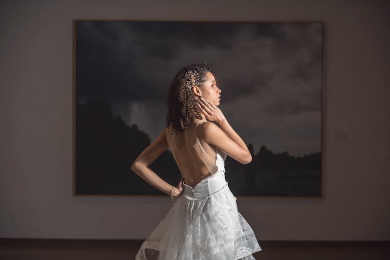 bride standing in front of painting