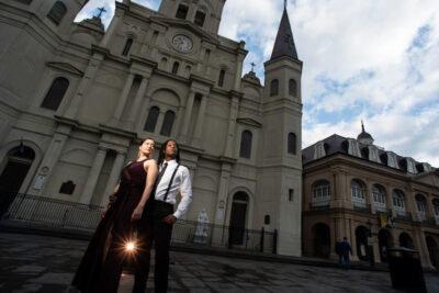 man and woman standing in front of large church building