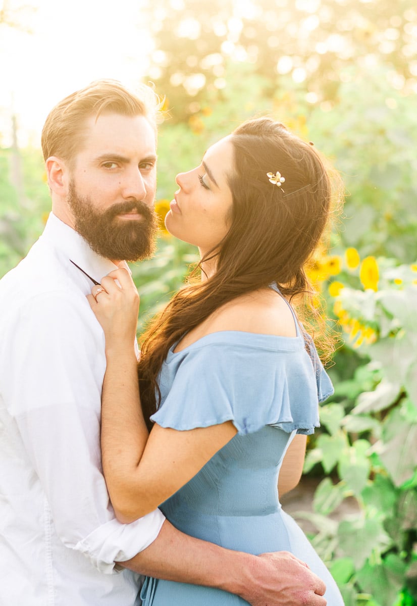 bearded man and woman in blue dress sunflower field marriage proposal