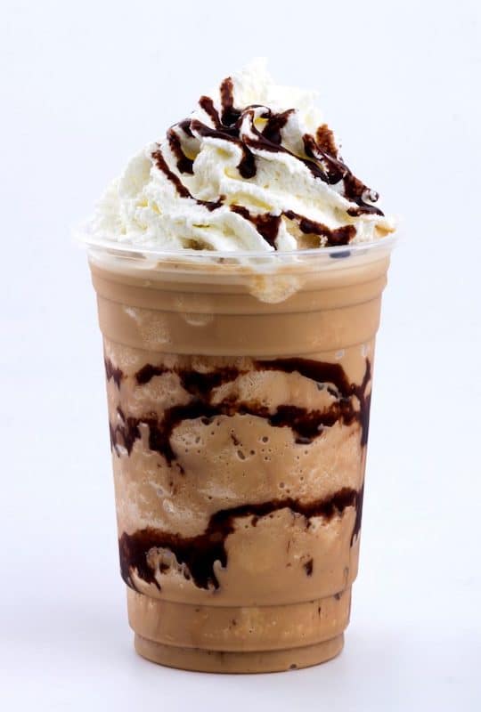 frozen coffee drink topped with whipped cream and chocolate syrup