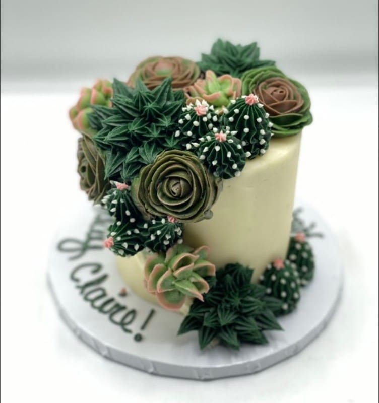 smal wedding cake decorated to look like it is covered in succulents