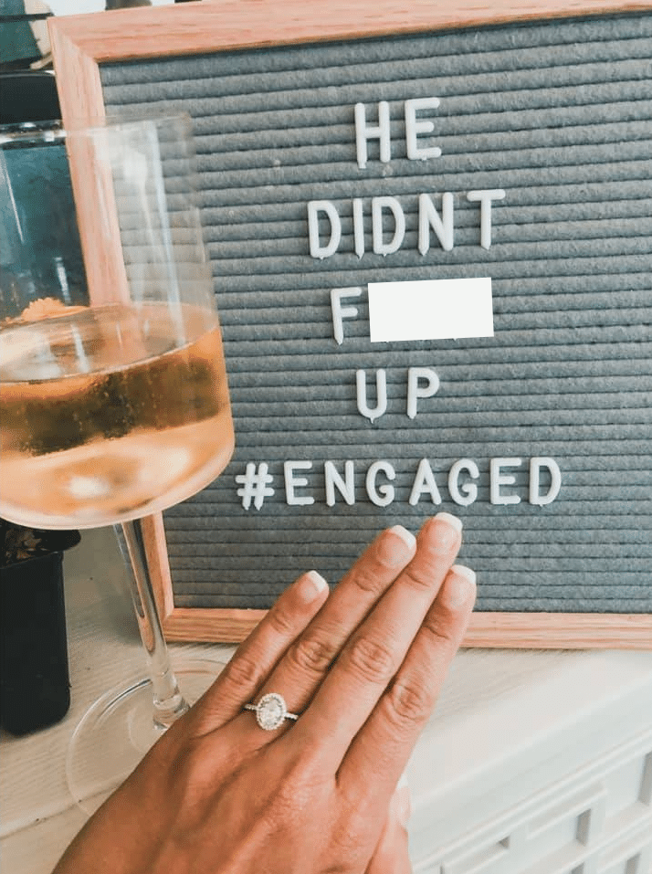 letter sign that reads he didnt f up # engaged with glass of champagne next to it and girl holding out hand with engagement ring on from their UCF Marriage proposal