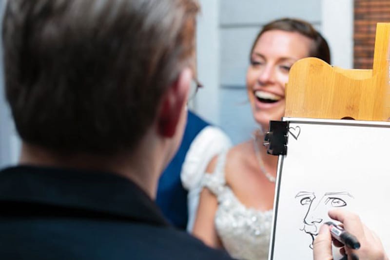 bride and groom posing for a caricature drawing from Artistic Talent Group