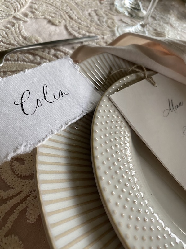 guests name written in calligraphy and placed next to their seat by Bare Lettered Designs