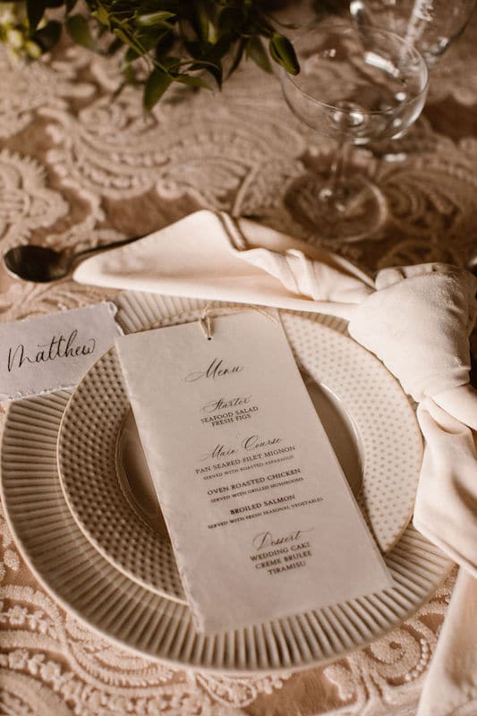 menu and name card placed on table during wedding reception prepared by Bare Lettered Calligraphy