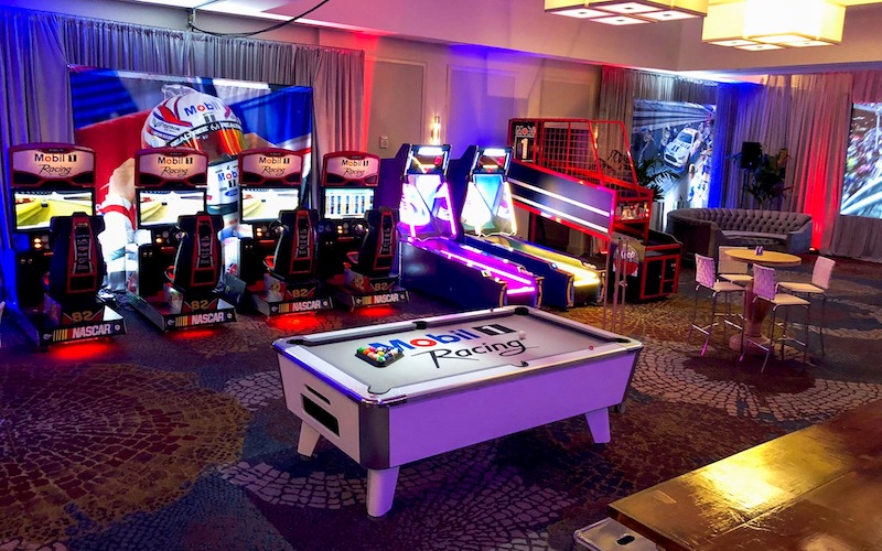 arcade set up for Mobil 1 Racing, with pool table, racing games, ski ball, and more