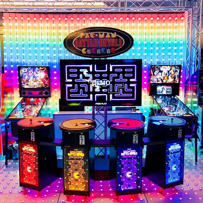 pac man battle royale arcade game, flanked by ghostbusters and star wars pinball games