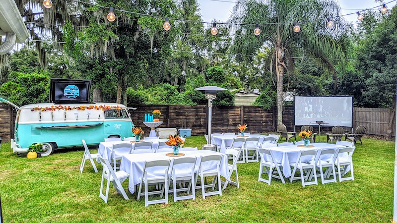 outdoor wedding reception area with Kombi Keg Volkswagen van set up nearby