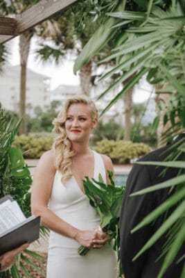 bride looking over at the officiant and smiling during her wedding ceremony