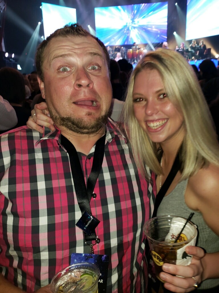 happy couple having a drink at a concert