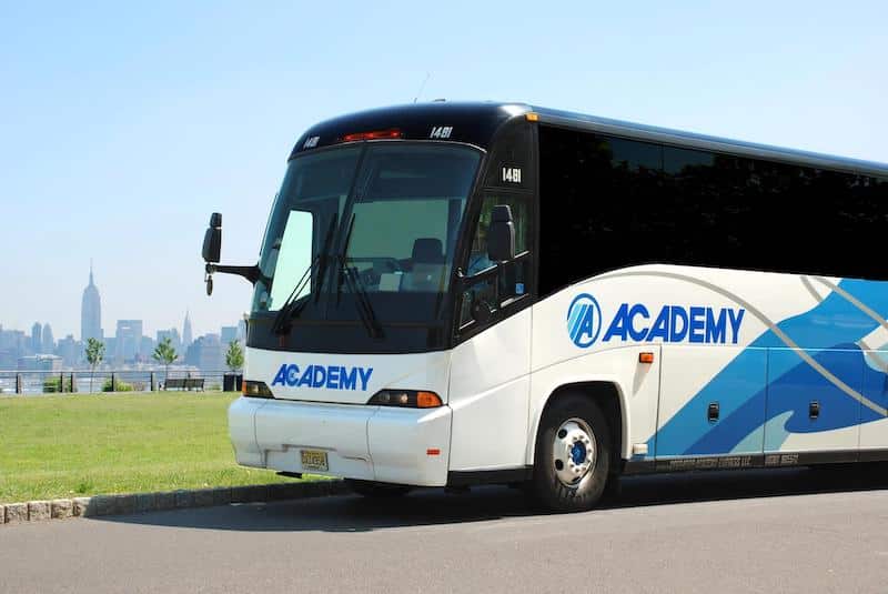 Academy Bus parked along side of the road