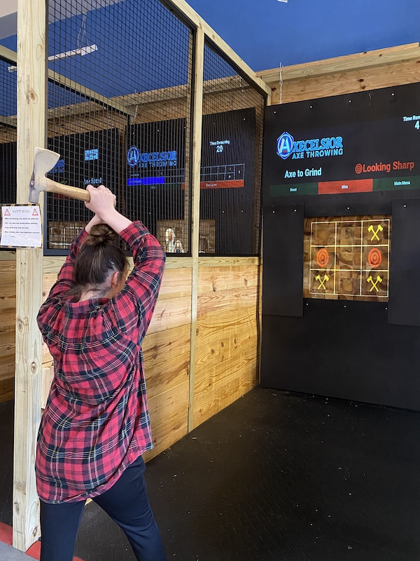 woman getting ready to throw an axe at Axecelsior Axe Throwing