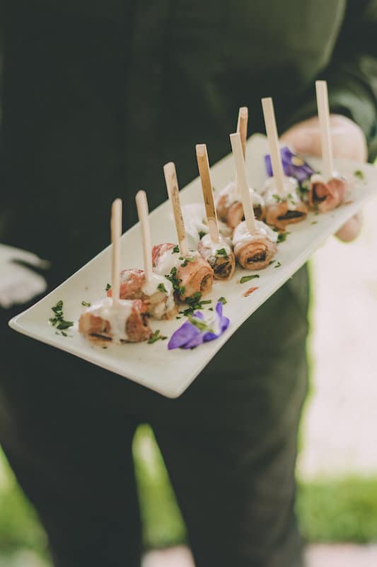 server holding a plate of hors d'oeuvres