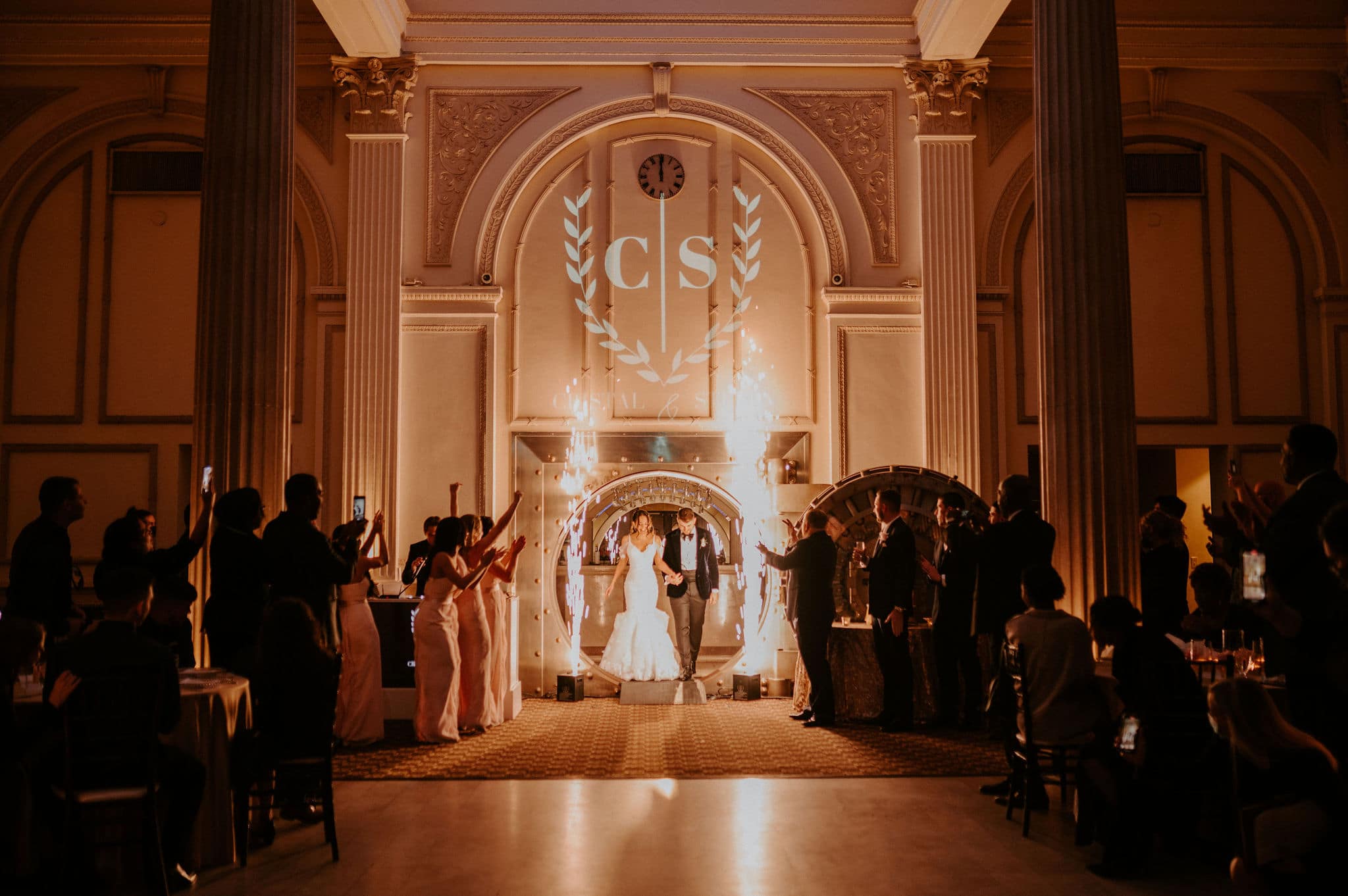 husband and wife entering their st. augustine winter wedding reception through a vault with wedding party surrounding them