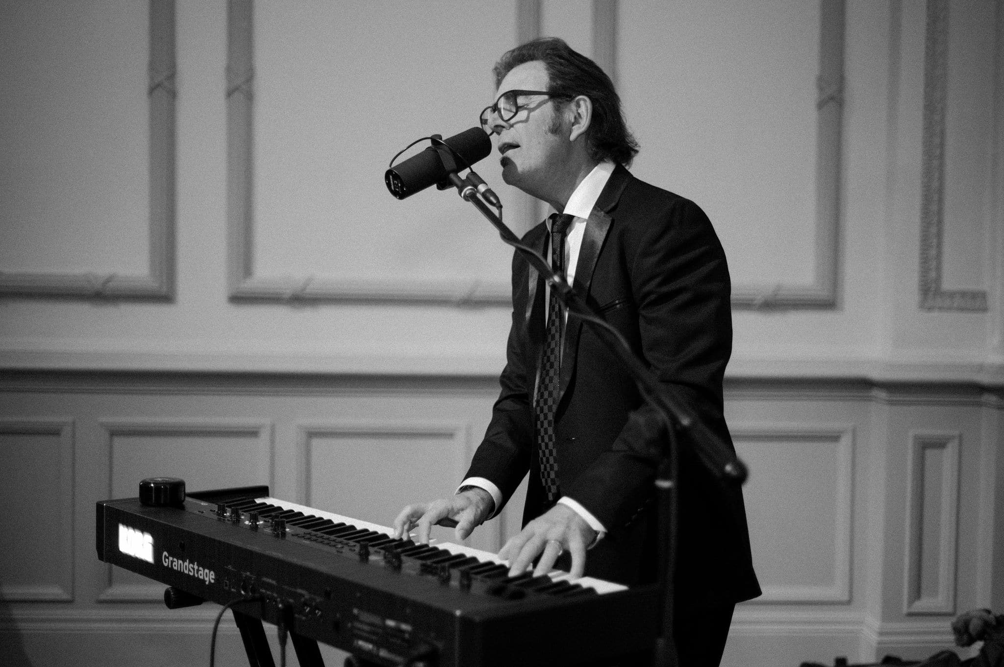 officiant's husband singing and playing piano