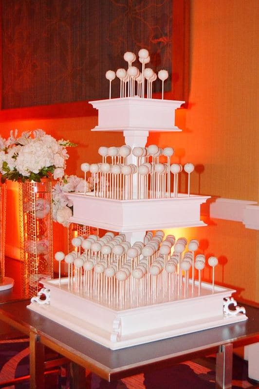 three tier tower filled with several white cake pops