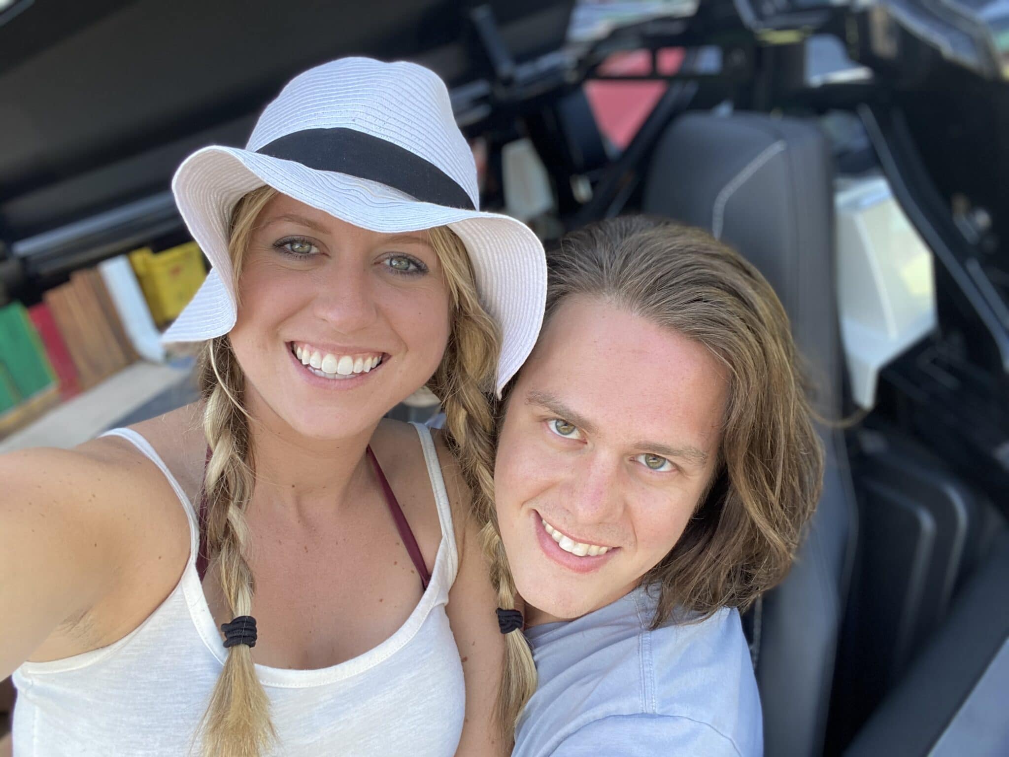 newly engaged couple sitting in golf cart and smiling together