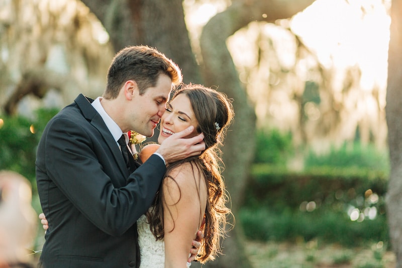 groom kissing his bride on their wedding day with planning by Weddings by Kasey
