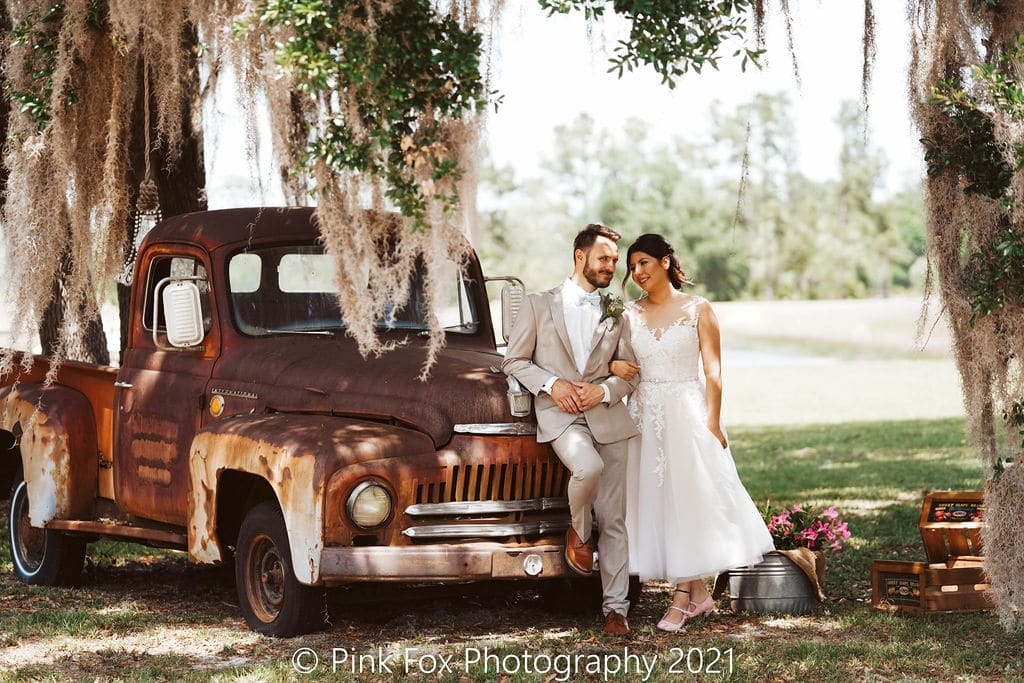 rustic truck with couple under tree