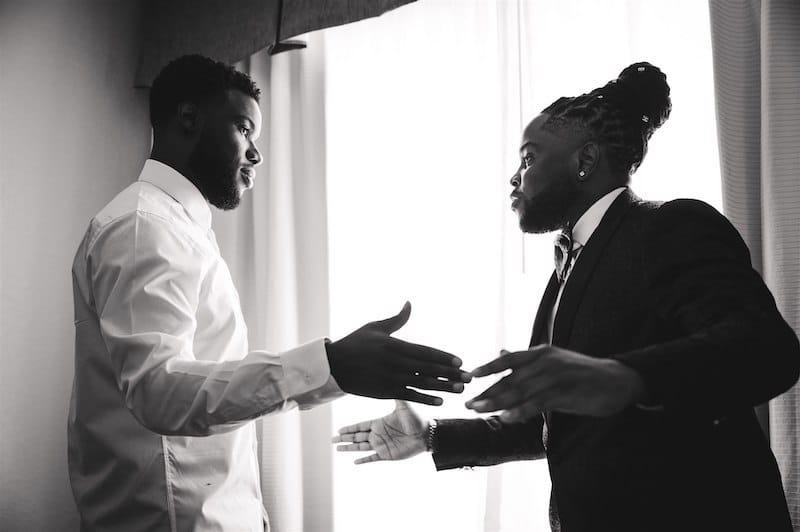 groom and best man about to embrace while preparing for the wedding, photo taken by Nativ Lens