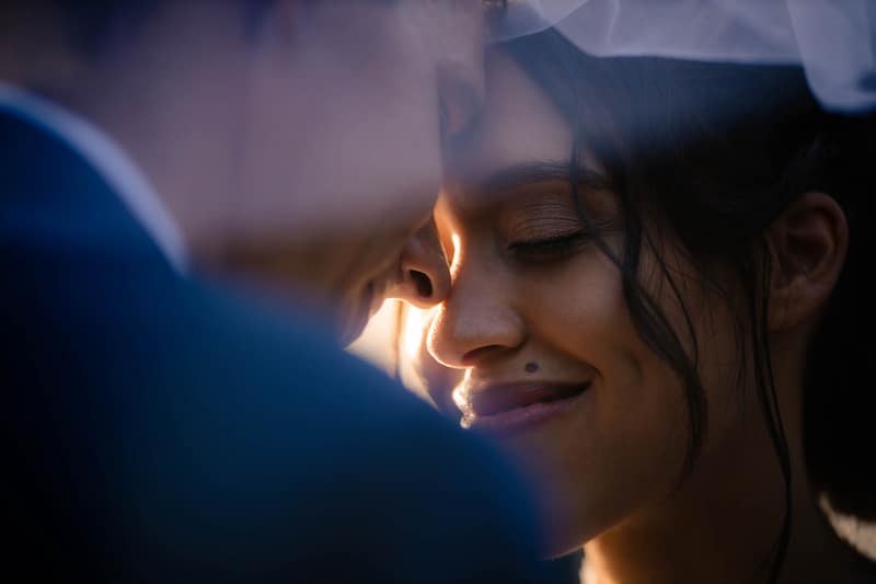 bride smiling while embracing her husband on their wedding day, photo taken by Nativ Lens