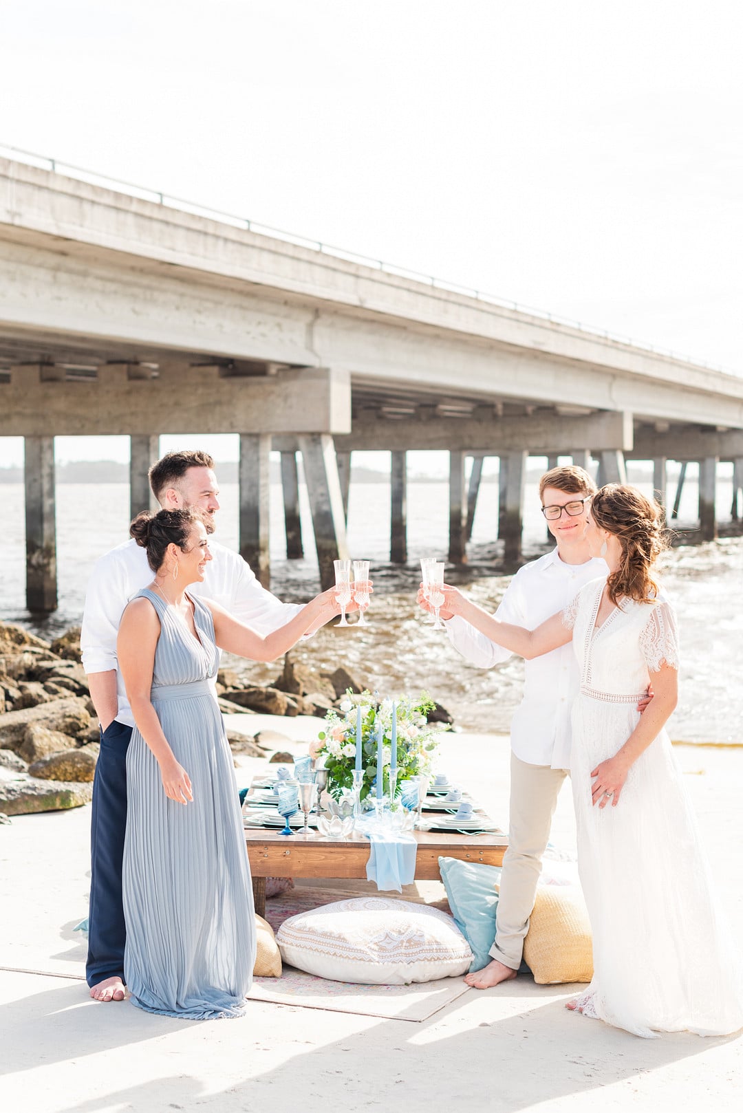 bride and groom toasting with their friends at the amelia island beach wedding inspiration shoot