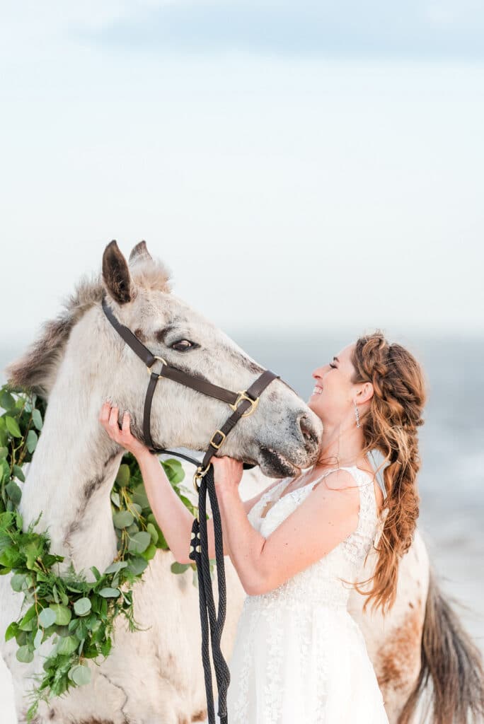 bride petting her horse on amelia island
