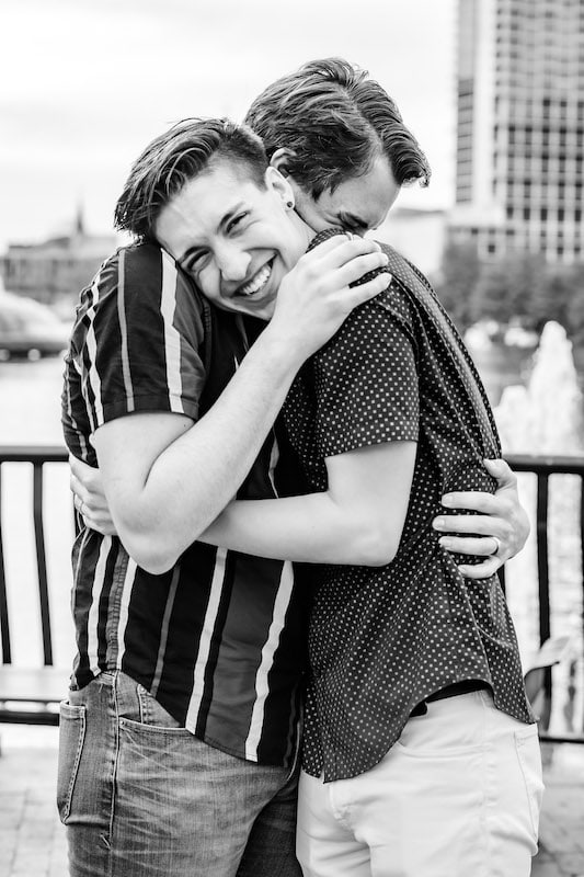 man smiling and hugging his fiancé after getting engaged, SMO Photography