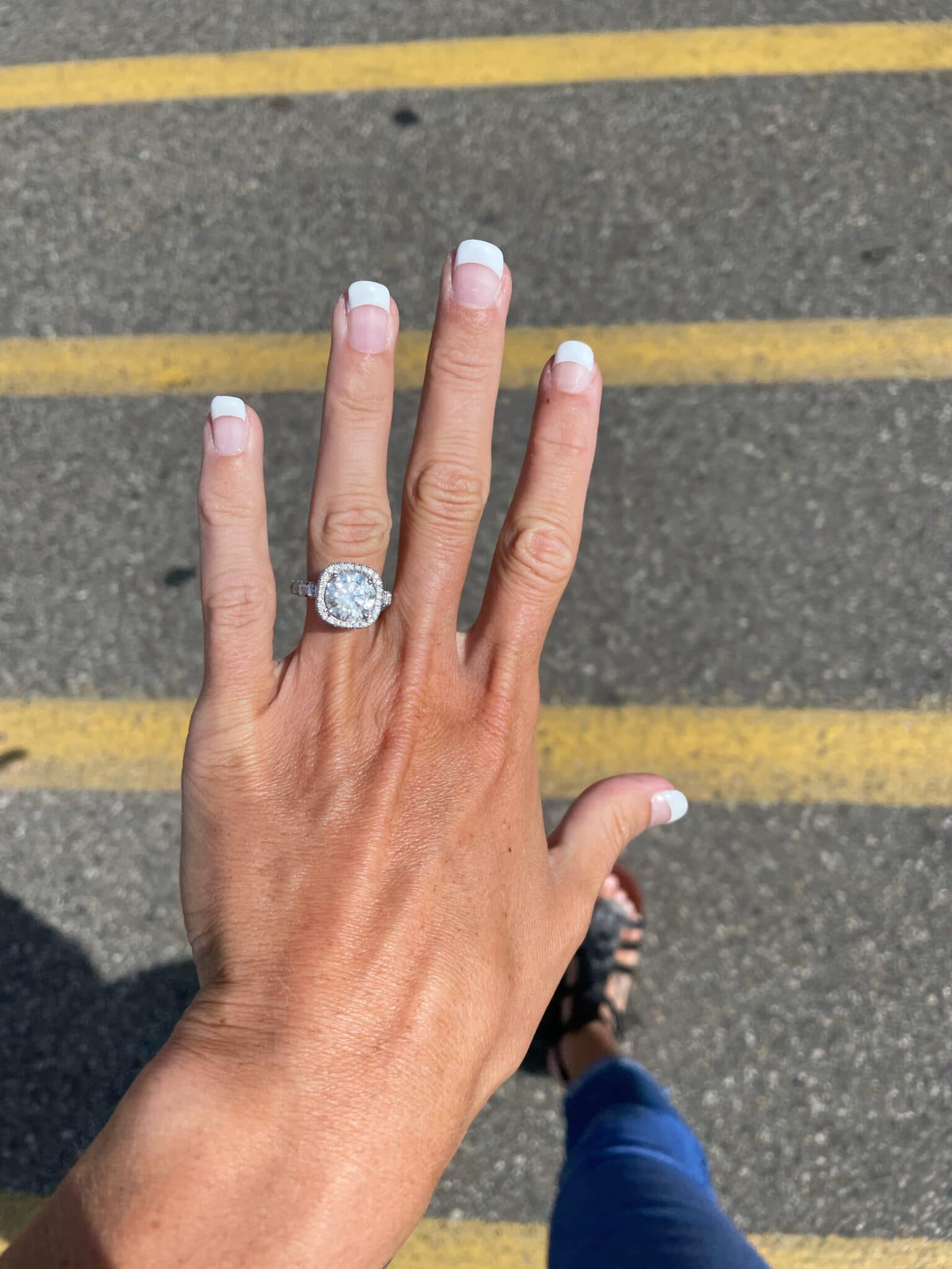 future bride's left hand with new engagement ring