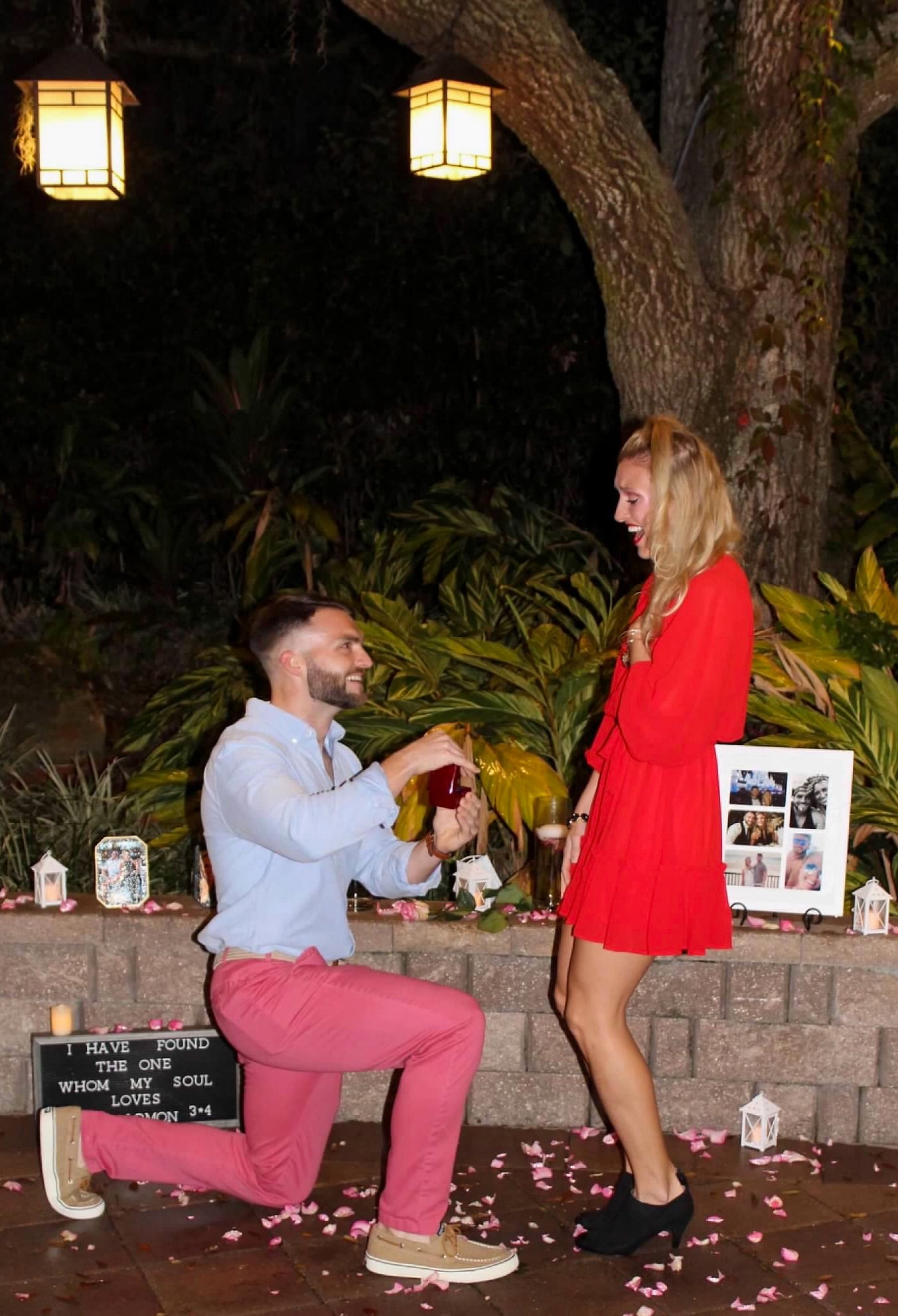 groom to be on one knee proposing to his wife to be at their staycation marriage proposal