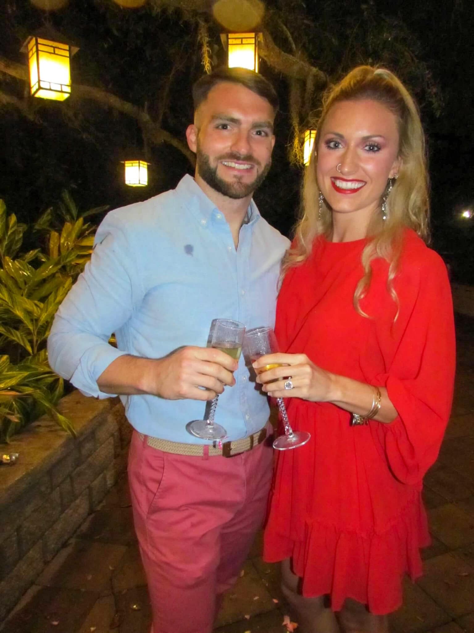 newly engaged couple with their champagne after their staycation marriage proposal