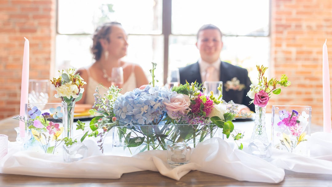 flowers on the sweetheart table at the summer bright wedding inspiration shoot